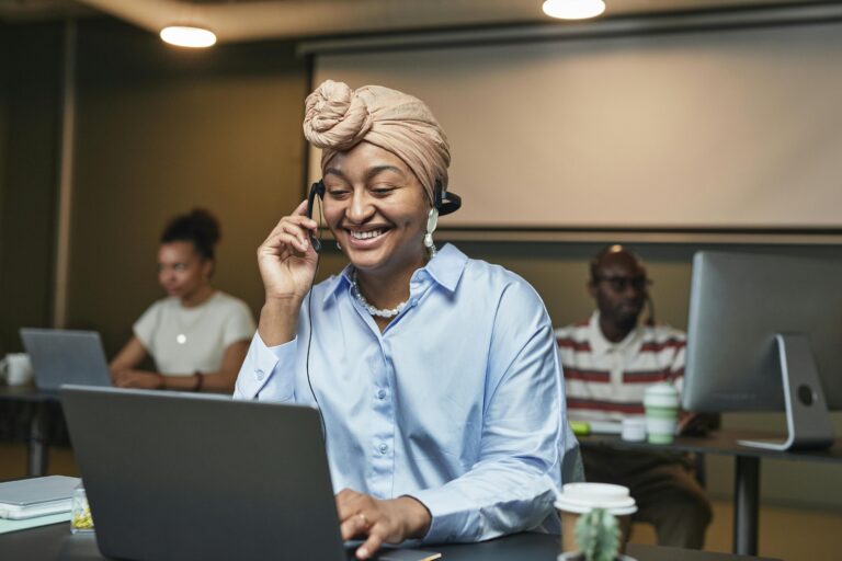 Confident woman working and communicating in a modern office with colleagues.